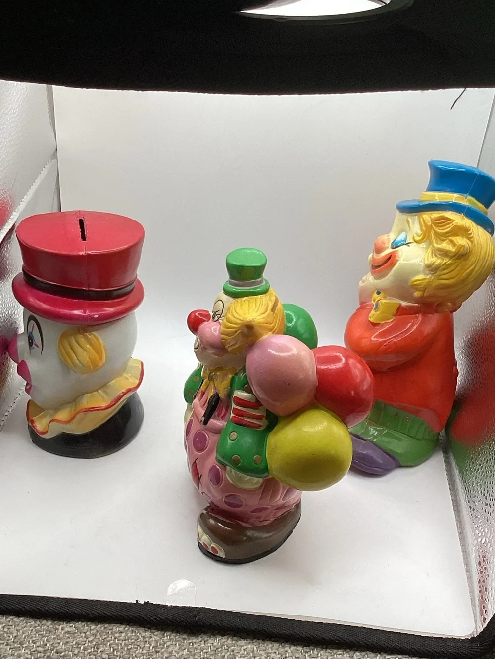 Three vintage 1980s hard plastic circus clown coin banks